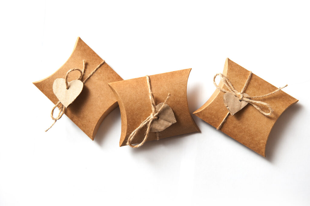 beautiful gifts of kraft paper with a heart on a white background on Valentine Day.