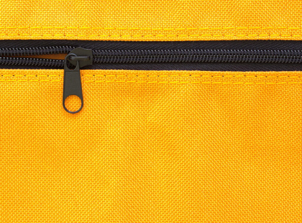 zipper on yellow bag background